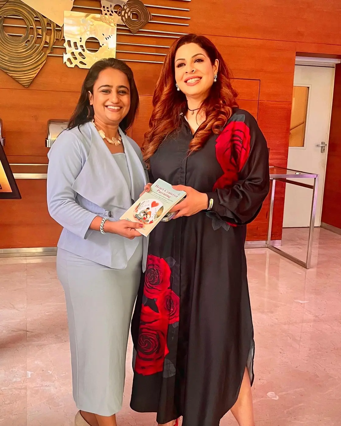 Chitra Jain Bhansali presenting her book to Tannaz Irani
