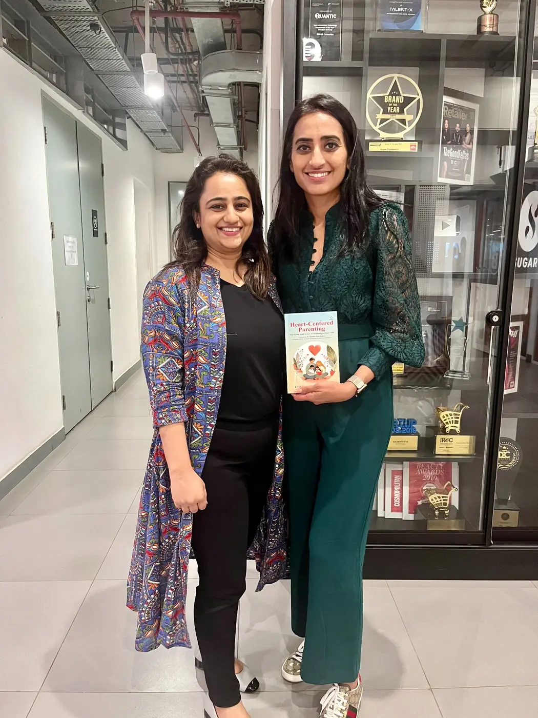 Chitra Jain Bhansali presenting her book to Vineeta Singh
